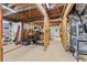 Unfinished basement with exposed wood beams, concrete floor, utilities, and potential for customization at 9950 Farmbrook Ln, Johns Creek, GA 30022