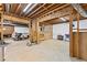 Unfinished basement offering ample space and potential for customization, including exposed beams and open layout at 9950 Farmbrook Ln, Johns Creek, GA 30022