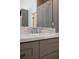 Bathroom vanity featuring marble countertop, a modern faucet, and gray shaker style cabinets at 9950 Farmbrook Ln, Johns Creek, GA 30022