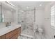 Renovated bathroom featuring glass enclosed shower with white marble tile and modern vanity at 9950 Farmbrook Ln, Johns Creek, GA 30022