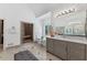 Bathroom featuring walk-in shower, double sink vanity and large mirrors at 9950 Farmbrook Ln, Johns Creek, GA 30022