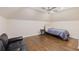 Spacious bedroom featuring hardwood floors, ceiling fan, and comfortable seating at 9950 Farmbrook Ln, Johns Creek, GA 30022