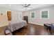 Spacious bedroom featuring hardwood floors, natural light, walk-in closet, and contemporary style at 9950 Farmbrook Ln, Johns Creek, GA 30022