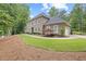 Beautifully landscaped home with a manicured lawn, complemented by mature trees for added privacy and appeal at 9950 Farmbrook Ln, Johns Creek, GA 30022