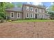 Beautiful two-story home with a well-manicured lawn, classic architecture, and a grand entrance exuding curb appeal at 9950 Farmbrook Ln, Johns Creek, GA 30022