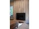 Modern fireplace with stone surround in a bright living room at 9950 Farmbrook Ln, Johns Creek, GA 30022