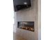 Modern fireplace with sleek stone surround and mounted television, creating a cozy and stylish focal point at 9950 Farmbrook Ln, Johns Creek, GA 30022