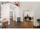 Open concept foyer showcasing hardwood floors, natural light, and seamless transition to the office and living spaces at 9950 Farmbrook Ln, Johns Creek, GA 30022