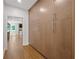 Hallway with hardwood floors and tall pantry cabinets at 9950 Farmbrook Ln, Johns Creek, GA 30022
