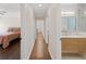 Hallway view features bedroom and updated bathroom at 9950 Farmbrook Ln, Johns Creek, GA 30022