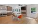 Bright open kitchen with breakfast area, modern fireplace, and hardwood floors at 9950 Farmbrook Ln, Johns Creek, GA 30022