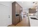 Bright kitchen features wood cabinets, stainless steel appliances, and a sink overlooking the living area at 9950 Farmbrook Ln, Johns Creek, GA 30022