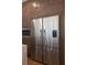 Modern kitchen features a large stainless steel refrigerator and sleek cabinetry at 9950 Farmbrook Ln, Johns Creek, GA 30022