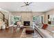 Inviting living room with fireplace, hardwood floors, and access to backyard at 9950 Farmbrook Ln, Johns Creek, GA 30022