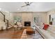 Bright living room with fireplace and access to backyard, featuring dark hardwood floors at 9950 Farmbrook Ln, Johns Creek, GA 30022