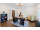 Stylish home office featuring a modern desk, custom lighting, and ample storage for a productive workspace at 9950 Farmbrook Ln, Johns Creek, GA 30022