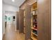 A well-organized pantry with ample shelving for storage, adjacent to hallway at 9950 Farmbrook Ln, Johns Creek, GA 30022