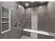 Walk-in shower with multiple shower heads and a marble seat at 9950 Farmbrook Ln, Johns Creek, GA 30022