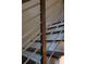 Close-up of a staircase with modern metal railings and wooden steps for a contemporary design at 9950 Farmbrook Ln, Johns Creek, GA 30022