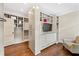 Well-organized walk-in closet with custom storage, drawers and a comfortable sitting area at 9950 Farmbrook Ln, Johns Creek, GA 30022