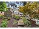 Stone steps lead to a backyard deck, offering a serene outdoor space with lush landscaping and mature trees at 11660 Crabapple Rd, Roswell, GA 30075