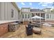 Spacious backyard patio with outdoor kitchen, seating, and views of the home's architecture and lush landscaping at 11660 Crabapple Rd, Roswell, GA 30075