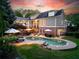 Backyard view featuring a luxurious pool, patio with lounge furniture, and well-maintained lawn at 11660 Crabapple Rd, Roswell, GA 30075