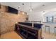 Basement bar area featuring brick wall, countertop, and seating at 11660 Crabapple Rd, Roswell, GA 30075