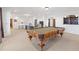 Finished basement with a pool table, bar area, and seating at 11660 Crabapple Rd, Roswell, GA 30075