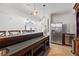 Entertainer's basement bar with seating, stainless steel appliances, and custom cabinetry at 11660 Crabapple Rd, Roswell, GA 30075