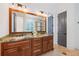 Spacious bathroom with double vanity, granite countertop, and a large mirror at 11660 Crabapple Rd, Roswell, GA 30075
