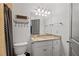 Traditional bathroom with granite countertop, undermount sink, and decorative storage at 11660 Crabapple Rd, Roswell, GA 30075