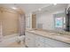 Bathroom featuring double sink with granite countertop and bathtub with tile surround and shower at 11660 Crabapple Rd, Roswell, GA 30075
