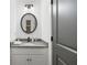 Stylish powder room with granite countertop and decorative mirror at 11660 Crabapple Rd, Roswell, GA 30075