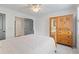 Well-lit bedroom featuring a bed with white bedding, an armoire, a ceiling fan, and white walls at 11660 Crabapple Rd, Roswell, GA 30075