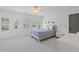 Bright bedroom with white walls, large windows with shutters, and a soft blue bedspread at 11660 Crabapple Rd, Roswell, GA 30075