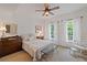 Bright bedroom with neutral tones and natural light from two windows at 11660 Crabapple Rd, Roswell, GA 30075