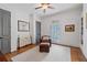 Cozy bedroom with hardwood floors, plantation shutters, and neutral color scheme at 11660 Crabapple Rd, Roswell, GA 30075