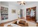 Bedroom features hardwood floors, white walls, and built-in bookshelves at 11660 Crabapple Rd, Roswell, GA 30075