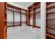 Custom walk-in closet with wooden shelving and ample storage space at 11660 Crabapple Rd, Roswell, GA 30075