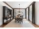 Formal dining room with hardwood floors, traditional lighting, and large windows at 11660 Crabapple Rd, Roswell, GA 30075