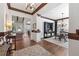 Open-concept room boasts wood floors, sophisticated trim, with views into living and dining areas at 11660 Crabapple Rd, Roswell, GA 30075