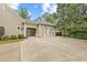Long driveway leading to a charming home with an attached garage and portico at 11660 Crabapple Rd, Roswell, GA 30075