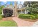View of landscaped front yard and home's exterior with stone chimney at 11660 Crabapple Rd, Roswell, GA 30075