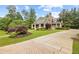 Beautifully landscaped home with a long driveway and lush greenery at 11660 Crabapple Rd, Roswell, GA 30075