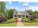 Charming home with manicured landscaping and inviting front porch, creating a warm and welcoming curb appeal at 11660 Crabapple Rd, Roswell, GA 30075