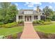 Charming home with a brick walkway, manicured landscaping, and covered porch at 11660 Crabapple Rd, Roswell, GA 30075