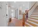 Hallway with brick floors leads to staircase and kitchen at 11660 Crabapple Rd, Roswell, GA 30075