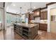 Open kitchen featuring a large island, custom cabinetry and stainless steel appliances at 11660 Crabapple Rd, Roswell, GA 30075