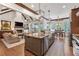 Bright, open kitchen featuring an oversized island, stainless steel appliances and brick fireplace at 11660 Crabapple Rd, Roswell, GA 30075